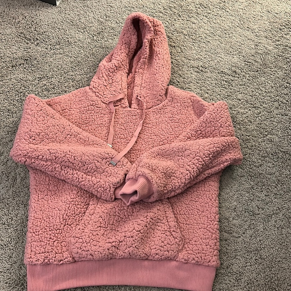 Reversible pink fuzzy sweat shirt.